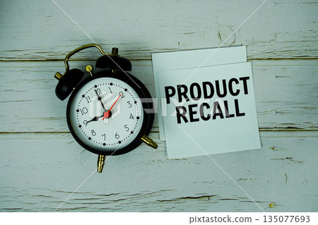 Product Recall text with alarm clock on wooden background 135077693