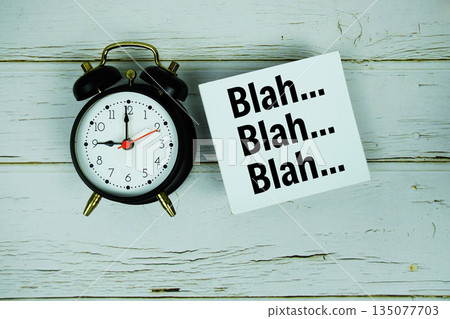Blah Blah Blah text with alarm clock on wooden background Blah Blah Blah text with alarm clock on wooden background 135077703