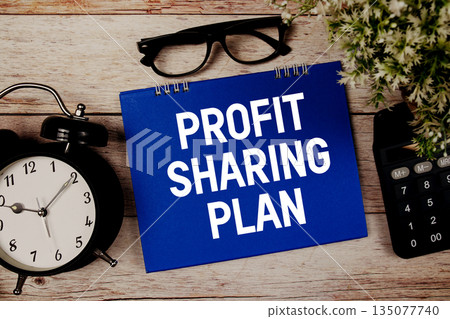 Profit Sharing Plan text with alarm clock and calculator on wooden background Profit Sharing Plan text with alarm clock and calculator on wooden background 135077740