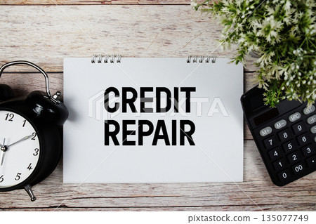 Credit Repair text with alarm clock and calculator on wooden background 135077749