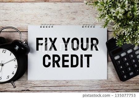 Fix Your Credit text with alarm clock and calculator on wooden background Fix Your Credit text with alarm clock and calculator on wooden background 135077753