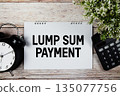 Lump Sum Payment text with alarm clock and calculator on wooden background 135077756
