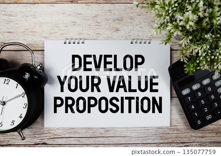 Value Proposition text with alarm clock and calculator on wooden background Value Proposition text with alarm clock and calculator on wooden background 135077759