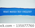 What Makes You Unique? message written on blue paper with torn paper background 135077760