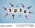 Happy New Year 2026 on cards with colorful arrows pointing toward it on blue background 135077786