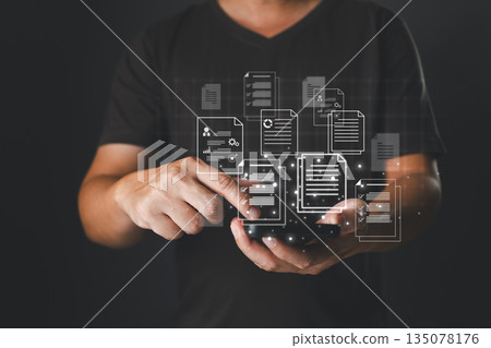 businessman interacts with a smartphone projecting glowing digital document icons, representing cloud storage, online data management, file organization, mobile access, and paperless workflow systems. 135078176