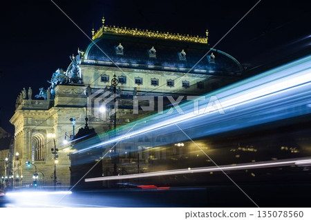 Historic classical building is glowing under warm lights in flat design, with tram light trails 135078560