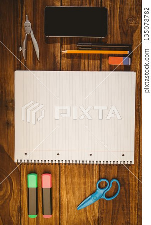 Open spiral-bound notebook is lying on wooden desk in flat design with smartphone and stationery Open spiral-bound notebook is lying on wooden desk in flat design with smartphone and stationery 135078782
