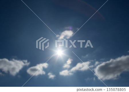 Low angle view of bright sun in sky Low angle view of bright sun in sky 135078805