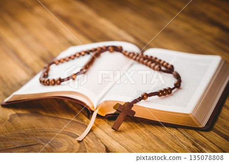 Rosary beads on open bible Rosary beads on open bible 135078808