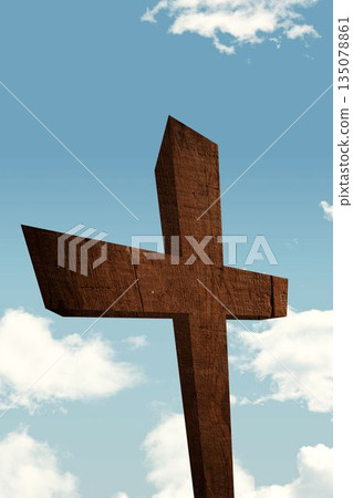 Weathered wooden cross is standing against clear blue sky with visible grain texture, flat design 135078861