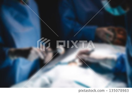 Surgery team operating a patient in an operating room 135078983