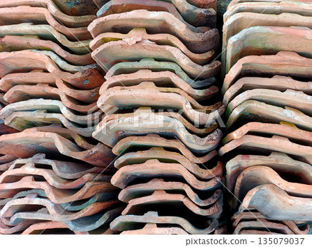 Close Up of Stacked Terracotta Roof Tiles Background Close Up of Stacked Terracotta Roof Tiles Background 135079037