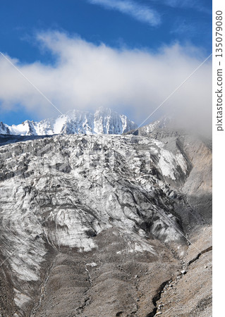 Majestic mountain range with large glacier on its slope, ice and rock formations 135079080
