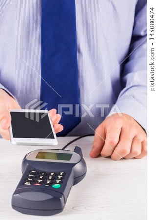 Man using smartphone to express pay 135080474