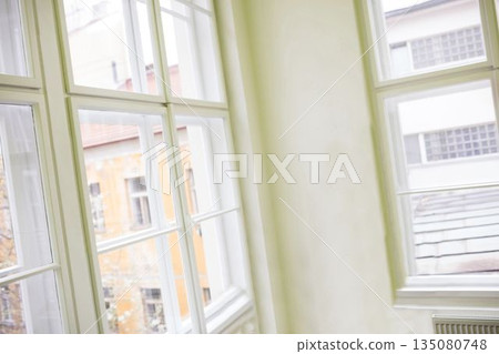 White-framed multi-pane windows are showing interior corner scene in flat design with plaster wall 135080748