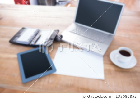 Laptop with digital tablet on table 135080852