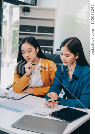 Businesswomen having discussion in office Businesswomen having discussion in office 135081242