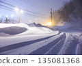 Tire tracks left on snowy roads. Gentle street lights shining on snowy roads late at night. 135081368
