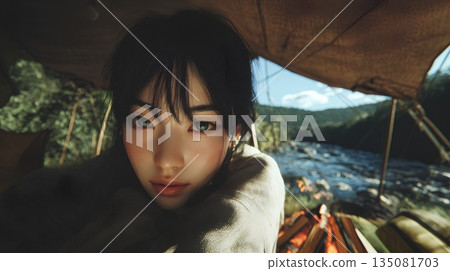 Woman camping by the river 135081703