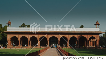 Red Fort Diwan-i-Am pavilion with red arches and manicured lawns against blue sky Red Fort Diwan-i-Am pavilion with red arches and manicured lawns against blue sky 135081747