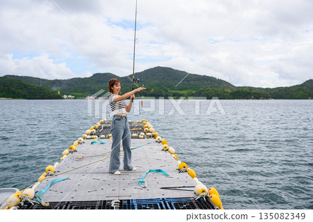 一位女子在海裡釣魚 [攝影合作：沖繩海濱度假村雅] 135082349