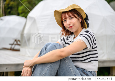 Woman in a straw hat and striped pattern [Photography cooperation: Oki Seaside Resort Miyabi] 135082371