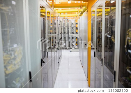Flat design showing narrow aisle of server cabinets with cables, bright overhead cable trays 135082500