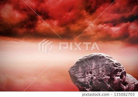 Large rock overlooking red sky 135082703