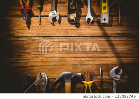 Flat design is showcasing pliers, screwdriver, wrench, hammer on wooden surface, copy space 135082749