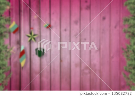 Blurred christmas decorations hanging over wood Blurred christmas decorations hanging over wood 135082782