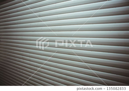 Metal rolling shutter door is being shown in flat design, highlighting repeating horizontal slats Metal rolling shutter door is being shown in flat design, highlighting repeating horizontal slats 135082833