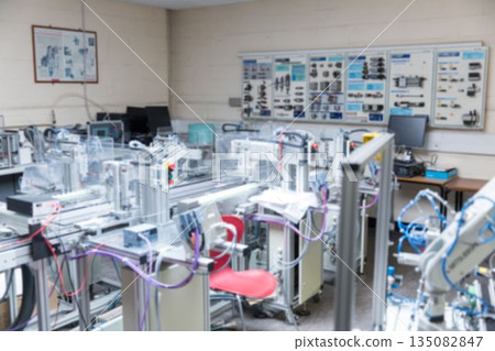 Flat design automation rigs are being shown in training workshop, with conveyors and control panels 135082847