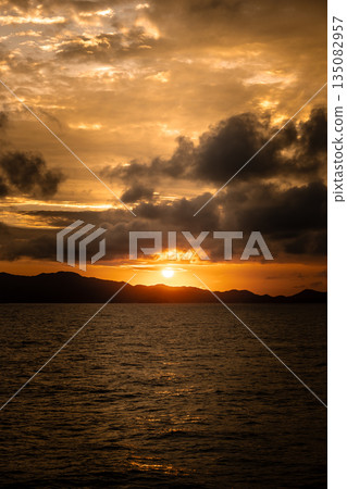 View of the sun setting over the sea View of the sun setting over the sea 135082957