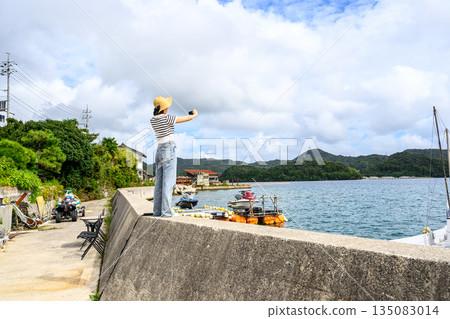 A woman taking a selfie at the beach (Photo courtesy of Oki Seaside Resort Miyabi) A woman taking a selfie at the beach (Photo courtesy of Oki Seaside Resort Miyabi) 135083014