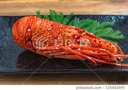 Delicious stewed lobster served on a black square plate 135083045