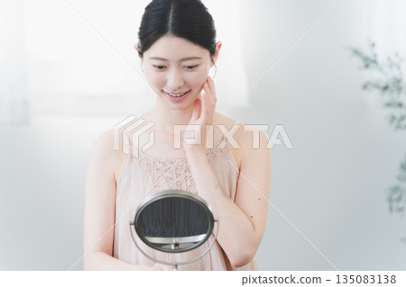 Beauty image of a young woman doing skin care Beauty image of a young woman doing skin care 135083138