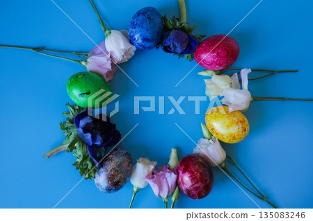 Beautiful spring flowers and easter eggs put in frame on blue background. Beautiful spring flowers and easter eggs put in frame on blue background. 135083246