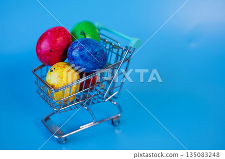 Happy Easter concept with easter eggs in shopping cart. Happy Easter concept with easter eggs in shopping cart. 135083248