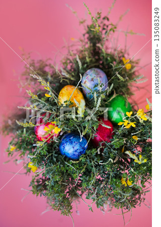 Beautiful bouquet of spring blooming bush with easter eggs on pink background.  135083249