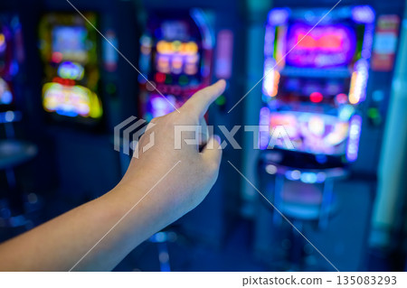 Hand pointing at a game console Hand pointing at a game console 135083293