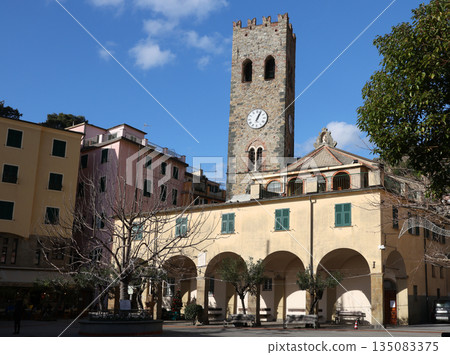 Central square with bell tower and clock in Monterosso, Italy. Historic center of town in Cinque Terre. Tourism and recreation. 135083375