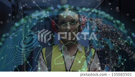 Monitoring network globe technician in data center corridor, wearing safety vest and red headphones Monitoring network globe technician in data center corridor, wearing safety vest and red headphones 135083501