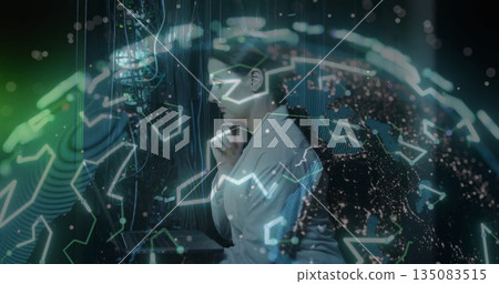 IT engineer in lab coat examining server racks, cables, LEDs and holographic globe in data center 135083515