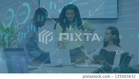 Reviewing data, three workers analyzing financial charts in conference room, laptop and tablet 135083632