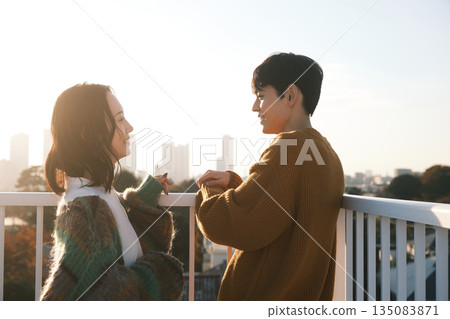 Couple hanging out on the rooftop 135083871