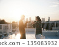 黃昏時分，一對情侶在屋頂上。 135083932
