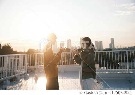Couple on the rooftop at dusk Couple on the rooftop at dusk 135083932