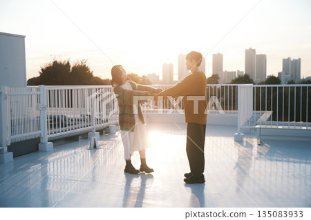 Couple on the rooftop at dusk Couple on the rooftop at dusk 135083933