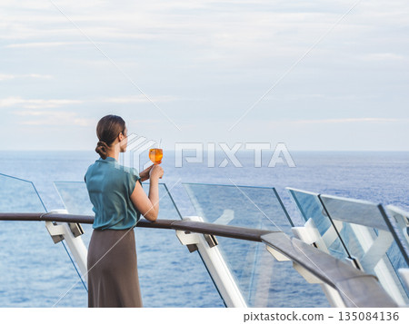 Stylish woman with a glass of drink 135084136